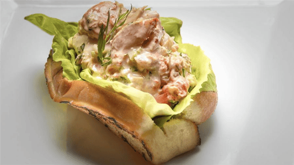 lobster roll with lettuce on a toasted bun