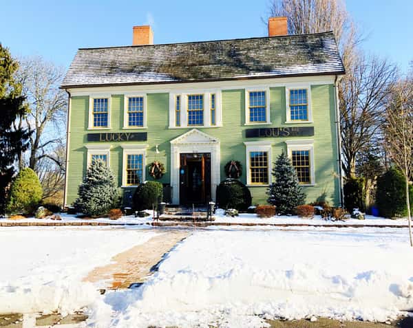 Picture of the front of Lucky lous bar and grill covered in snow
