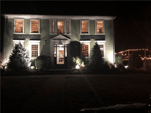 view of front of the restaurant at night with lights illuminating the outside