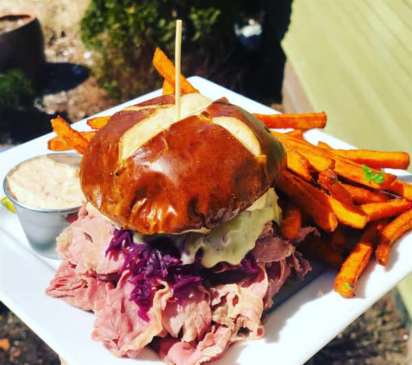 roast beef on a brioche bun with a side of sweet potato fries