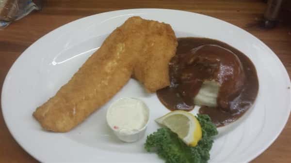 Fried fish served with a side of mashed potatoes and gravy