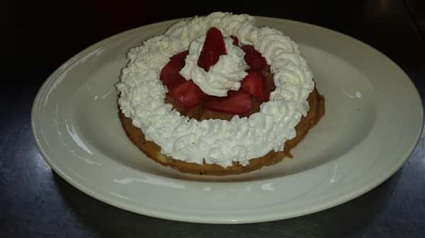 Belgian waffle with whipped cream and strawberries