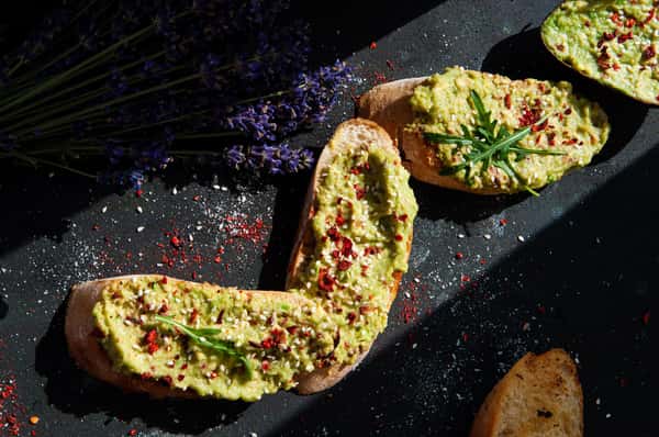 appetizing-guacamole-toasts-garnished-with-spices-and-herbs--original.jpg