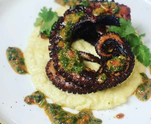 Indulge in this delicacy! Our Fried Octopus is made with creamy polenta and topped with fresh salsa verde; it's sure to delight your tastebuds!