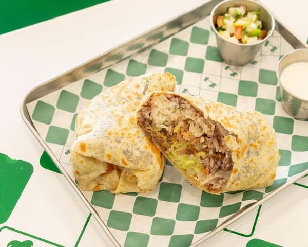 Grilled flour tortilla burrito stuffed with seasoned steak, rice, beans, and fresh toppings, served with pico de gallo and crema—hearty Mexican comfort food.