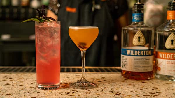 Signature cocktails at an upscale restaurant bar featuring handcrafted drinks and premium spirits