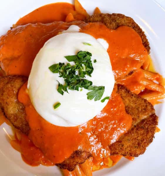 Breaded Chicken Cutlet Over Penne in Vodka Sauce, crispy chicken cutlet, penne alla vodka, homemade burrata, creamy vodka sauce, Italian comfort food, best chicken vodka pasta, Hoboken Italian restaurant, breaded chicken pasta, rich and creamy vodka sauce, fresh burrata topping, classic Italian flavors, hand-breaded chicken cutlet, cheesy pasta dish, indulgent Italian meal, San Giuseppe signature dish, authentic Italian cuisine, crispy chicken with pasta, homemade burrata cheese, pasta lovers' favorite, hearty Italian entrée.