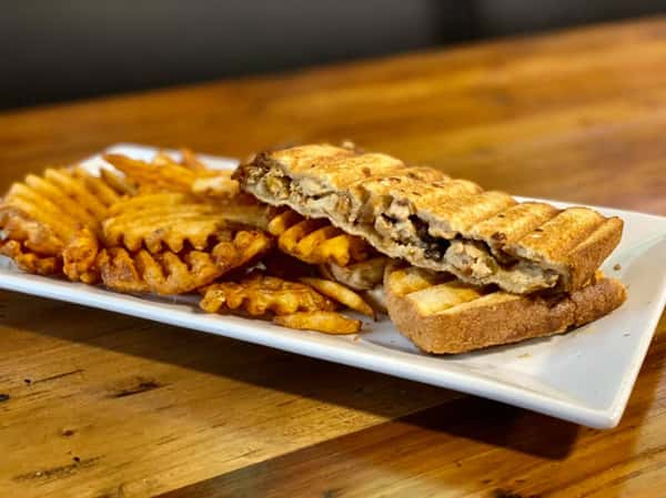 grilled panini with a side of fries