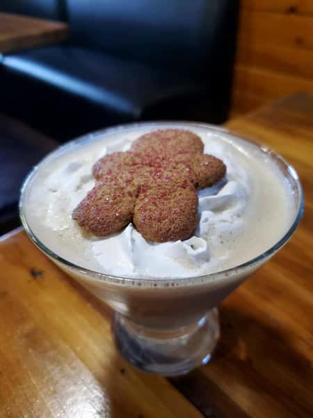 gingerbread martini topped with a gingerbread cookie