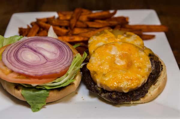 open faced cheeseburger with lettuce, tomato, and onions