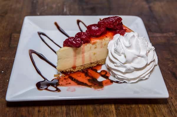 raspberry cheesecake with a side of whipped cream