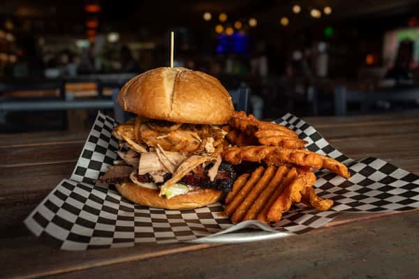 The Boz sandwich. slow smoked chicken, brisket and pulled pork with slaw, frizzled onions and garlic aioli.