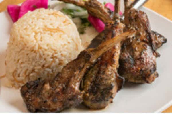 Grilled lamb chops served with seasoned rice and pickled vegetables