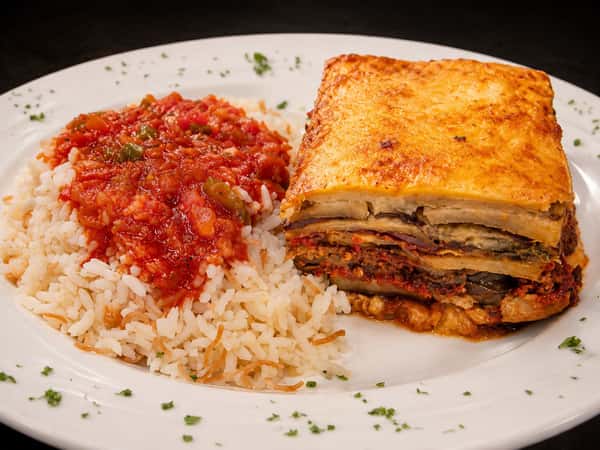 Greek moussaka served with seasoned rice and tomato sauce