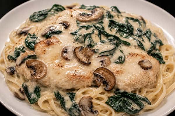 Chicken Florentine with spinach, mushrooms, and pasta in a creamy sauce