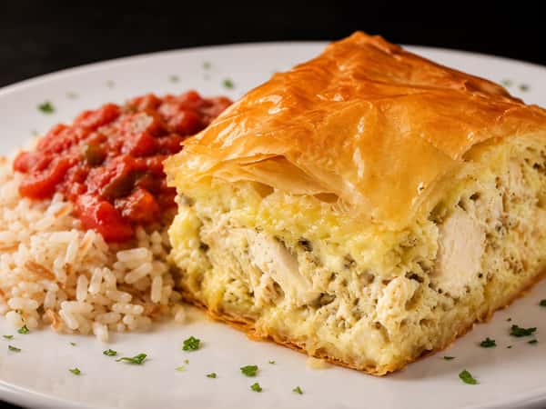 Flaky artichoke pie served with seasoned rice and tomato sauce