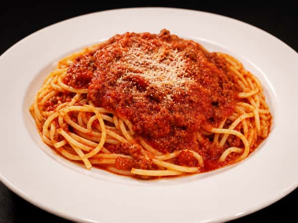 Spaghetti topped with hearty meat sauce and grated Parmesan