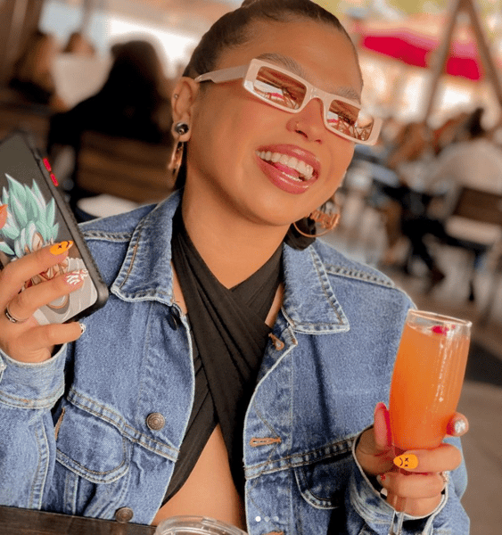 Happy customer with drink and phone in hands