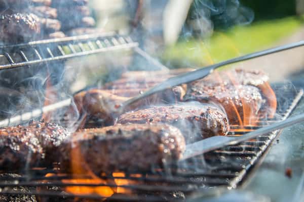 Smoky, sizzling burgers are being flipped on a grill at City Limits Bar and Grill.