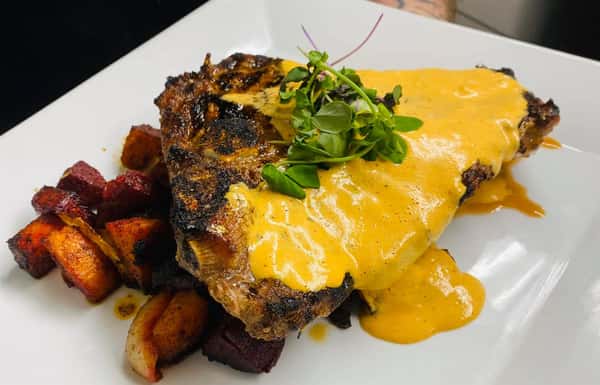 16oz Porterhouse Steak with Chipotle Hollandaise and Cumin Roasted Root Vegetable Medley