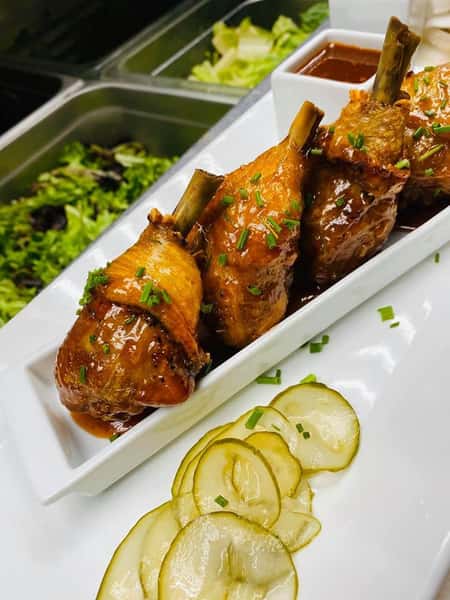 Chicken Lollipops: brined and smoked chicken legs, Valley BBQ sauce, house-pickled cucumbers, homemade chipotle hot sauce for dipping