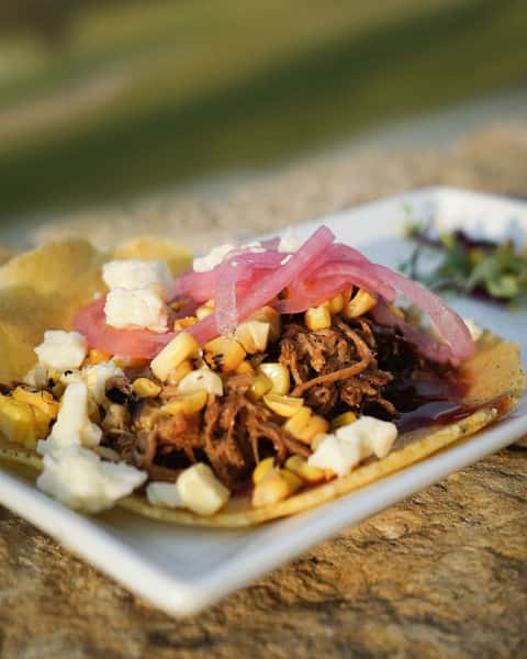 tacos with chredded meat, pickled cabbage, corn and cheese