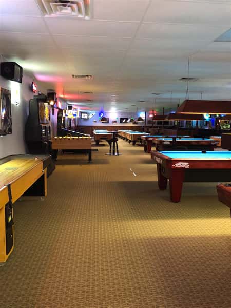 interior view of business with pool tables and lights up above