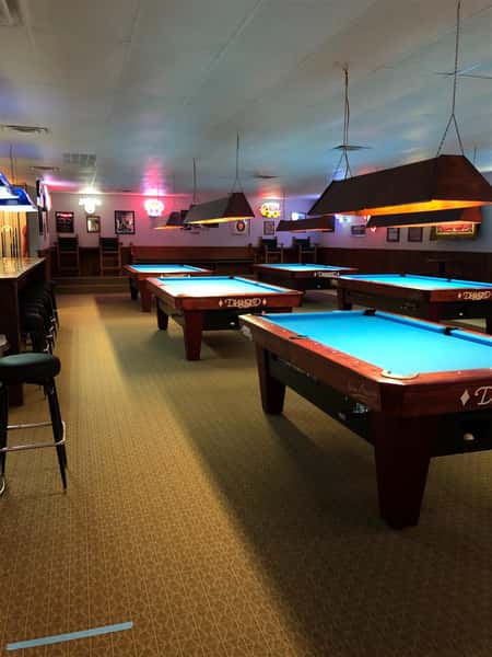 interior view of business with pool tables and lights up above
