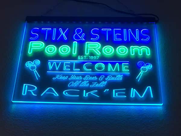 neon sign that reads "Stix & Steins Pool Room Est. 1997 Welcome - Keep your Beer and Butts off the felt! Rack'em
