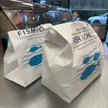 Fish and chips takeaway orders packed in traditional paper bags
