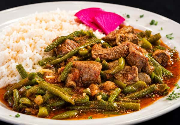 Lamb and green beans cooked in a savory tomato sauce and served with rice