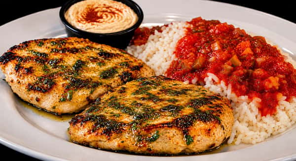 Grilled cilantro chicken served with rice, tomato sauce, and hummus