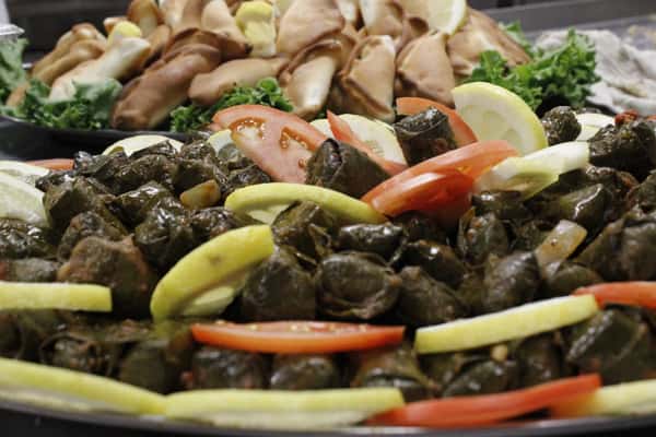 Traditional stuffed grape leaves served with fresh vegetables.