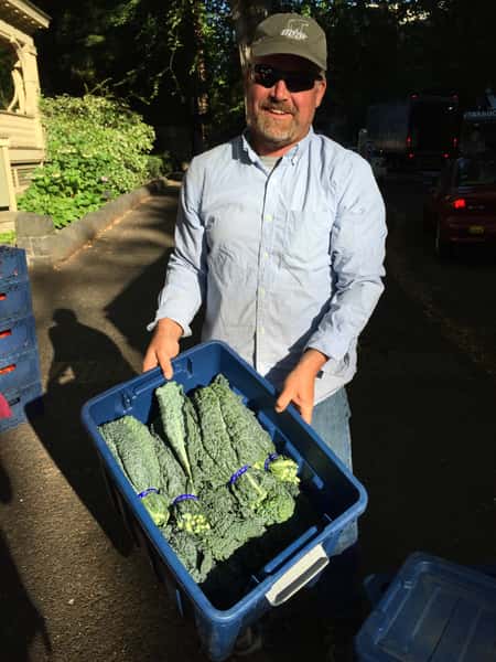 man holding green produce