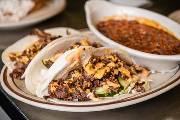 Beef BBQ tacos with a side of beans