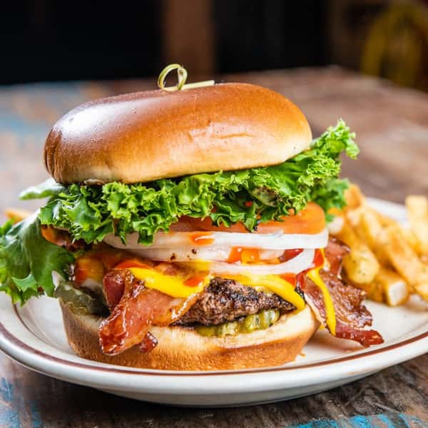 1A bacon cheeseburger topped with onion, tomato, and lettuce