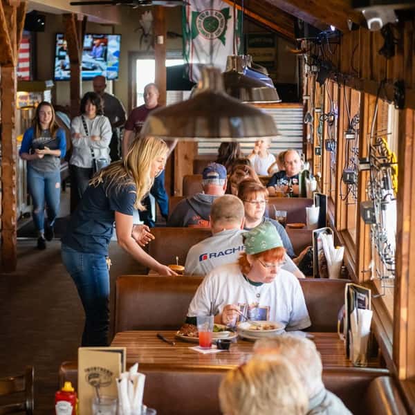 Booths of tables filled with families eating their meals