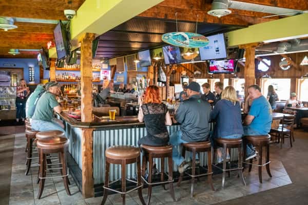 Customers eating and sitting at the bar
