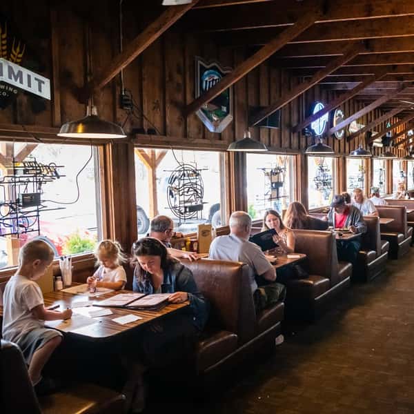 A view of customers sitting at the booth seating area of the dining room
