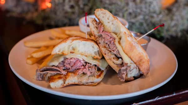sliced prime rib and melted gruyere and sautéed onions on a
crusty roll served with creamed horseradish, au jus, and
french fries