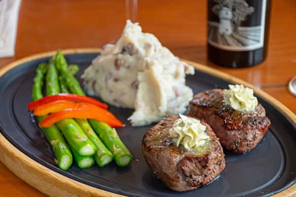 Grilled filet mignon with herb butter, asparagus, red peppers, and mashed potatoes.