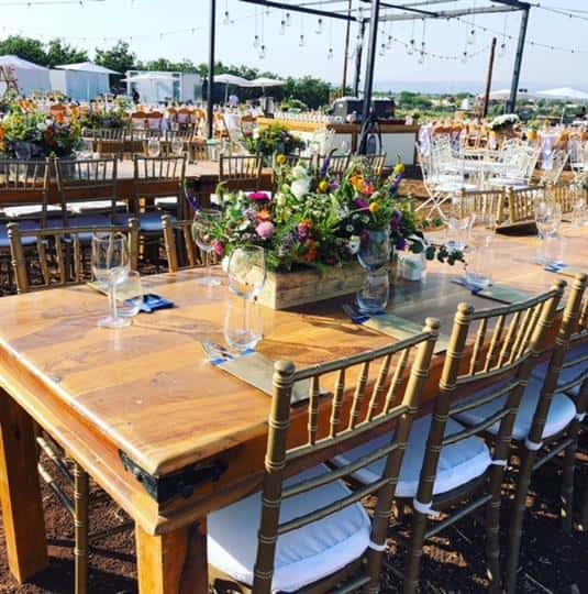 Wood tables in outdoor catering setup