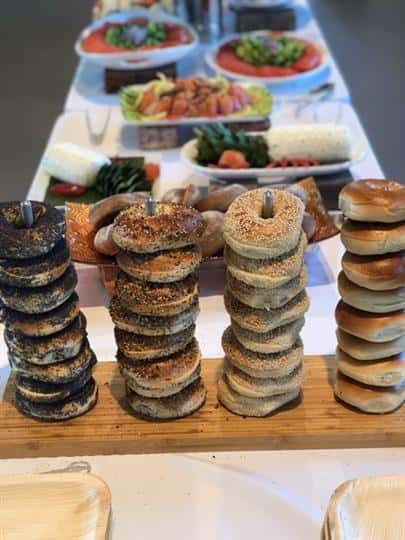 assorted bagels stacked on wood board