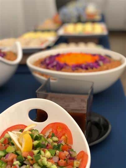 Bowls with chopped vegetables and dips