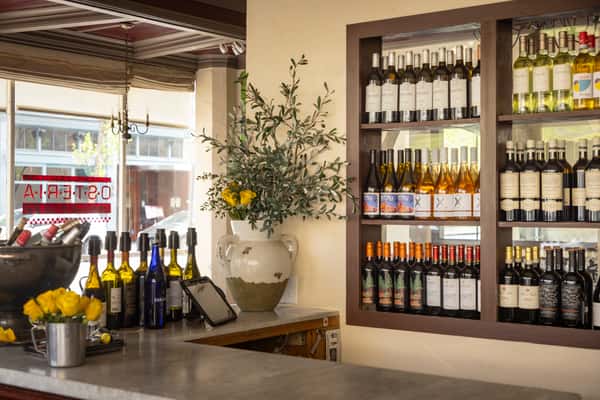 Italian wine selection displayed on shelves inside the restaurant