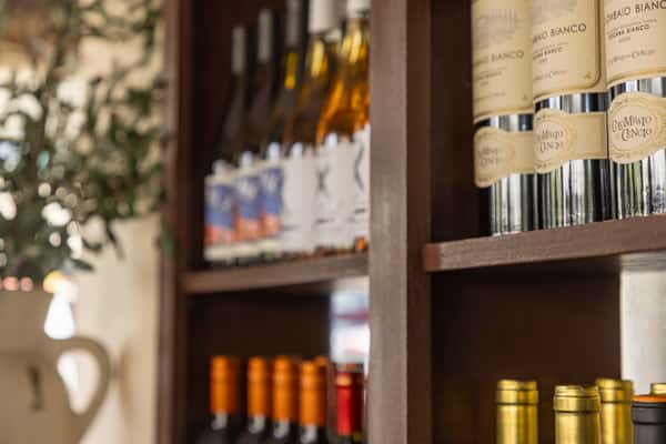 Italian wine selection displayed on shelves inside the restaurant