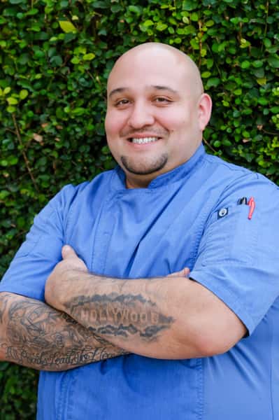 Chef Jesus De Leon standing in front of Greater Pacific Restaurant