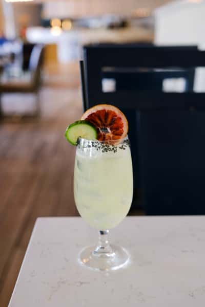 Specialty cocktail with a cucumber and citrus slice