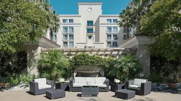 Outdoor patio area with lounge couches, chairs and tables
