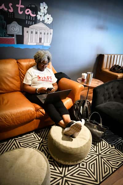 Woman with laptop in the lounge seating area